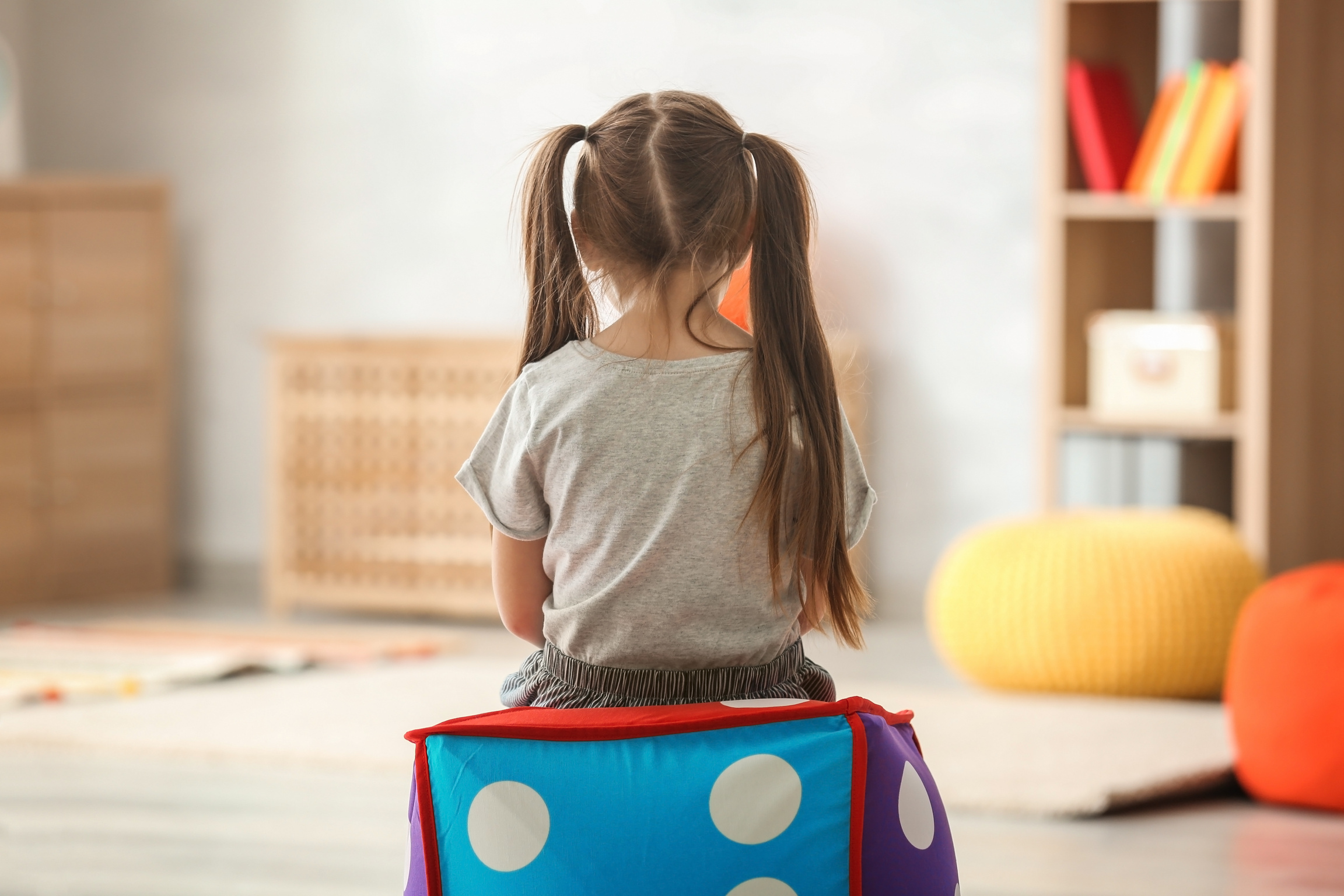 Little Girl Sitting Alone at Home