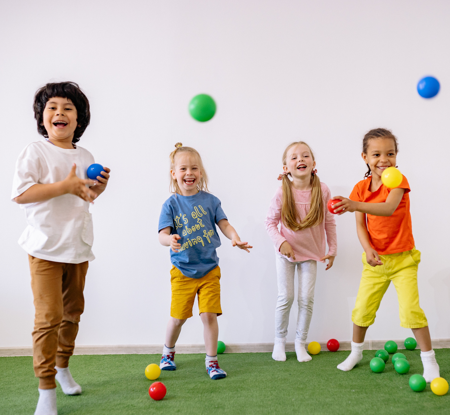 Happy Children Playing With Colorful Plastic Balls